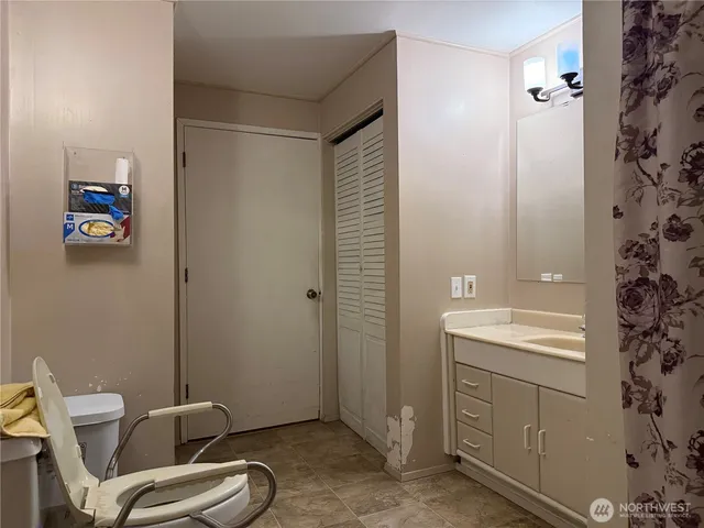 a bathroom with a toilet a sink and mirror