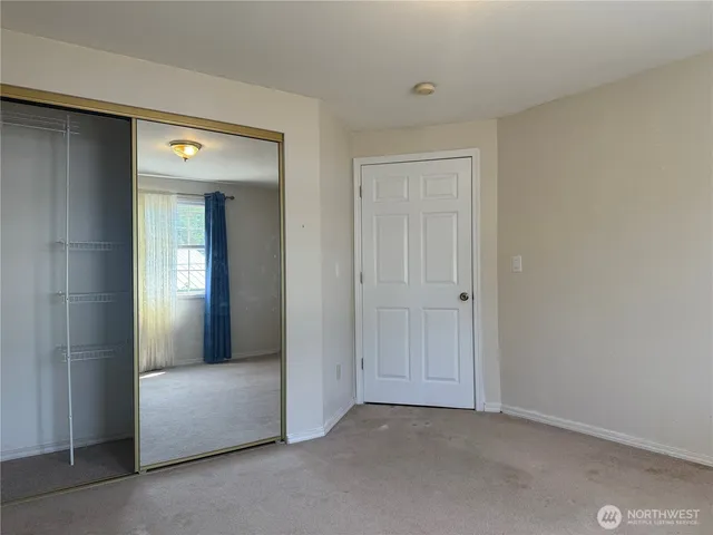 a view of an empty room and closet in a room