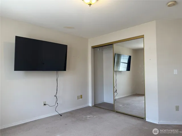 a living room with a flat screen tv and a potted plant