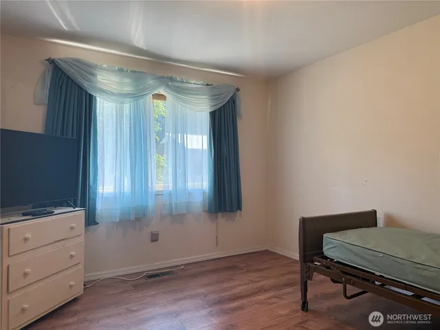 a room with painting on the wall and a potted plant