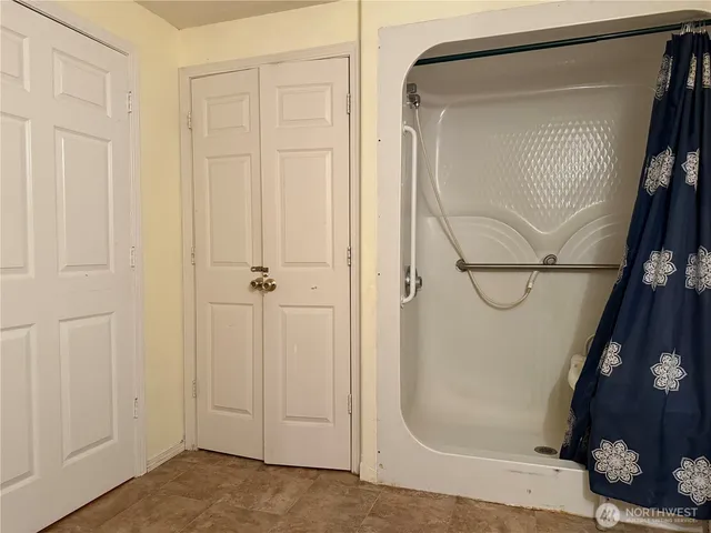 an empty room with closet and entrance