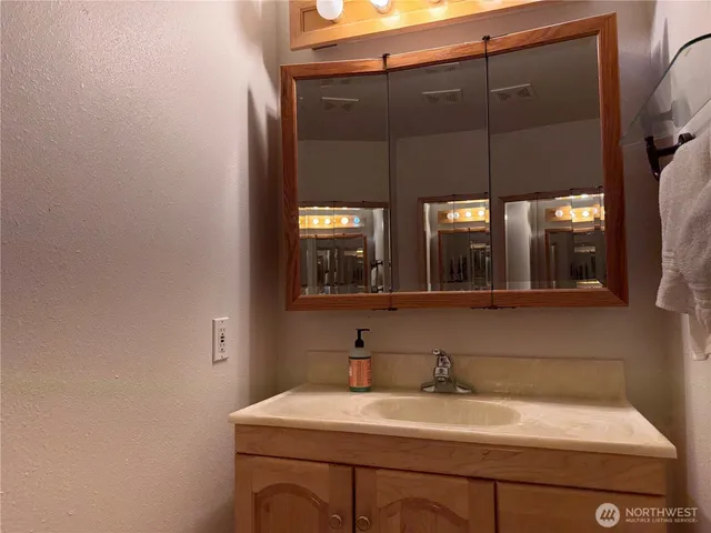 a bathroom with a toilet a sink and mirror