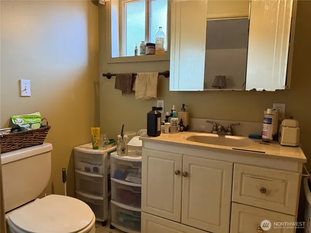an aerial view of a house with a yard and mountain view in back