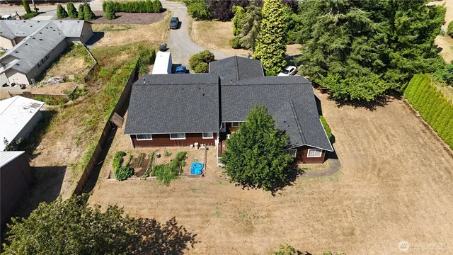 an aerial view of a house with a yard and garden