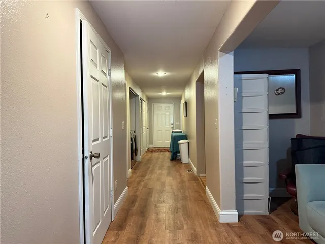 a view of hallway with wooden floor