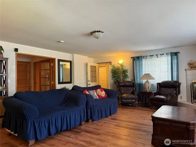 a living room with furniture a lamp and large window