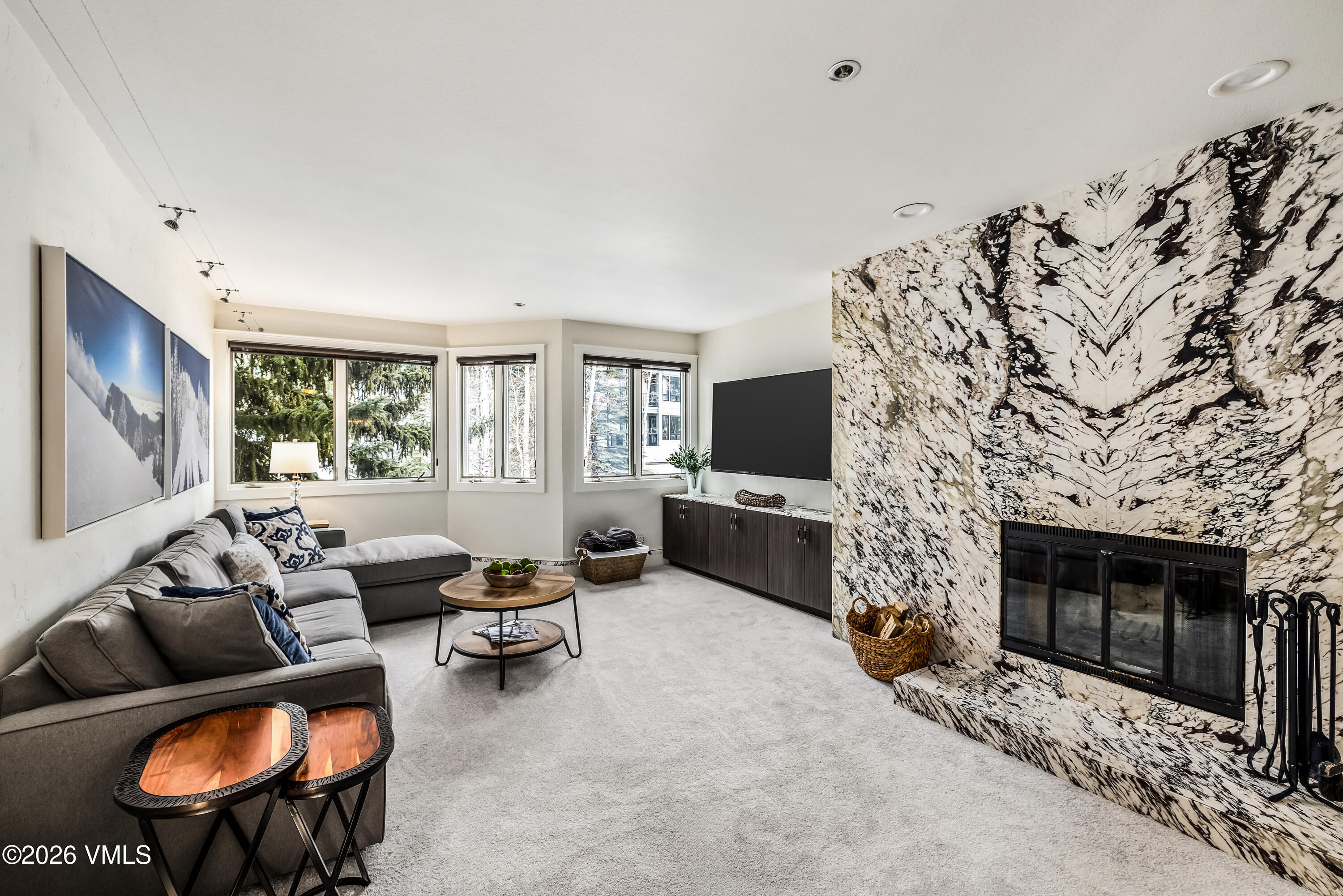 311 Offerson Road, Unit 223 Beaver Creek, CO 81620 - Photo 12 of 37 a living room with furniture a flat screen tv and a fireplace