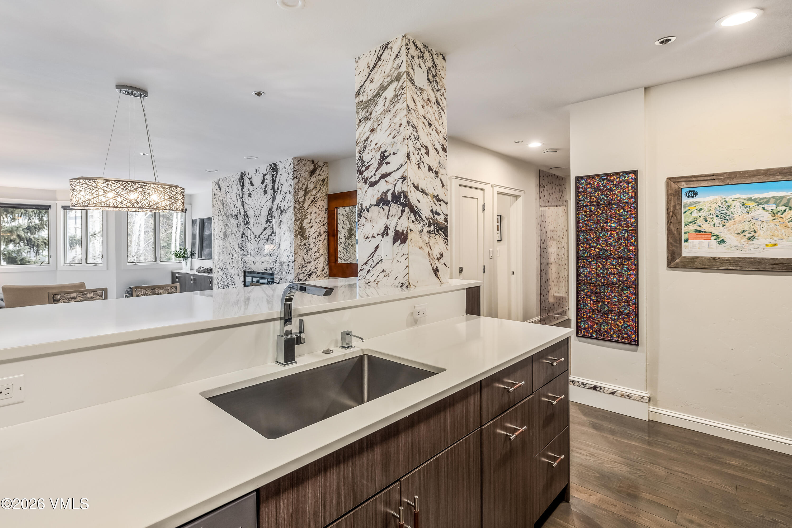 311 Offerson Road, Unit 223 Beaver Creek, CO 81620 - Photo 13 of 37 a view of a kitchen island a sink and wooden floor