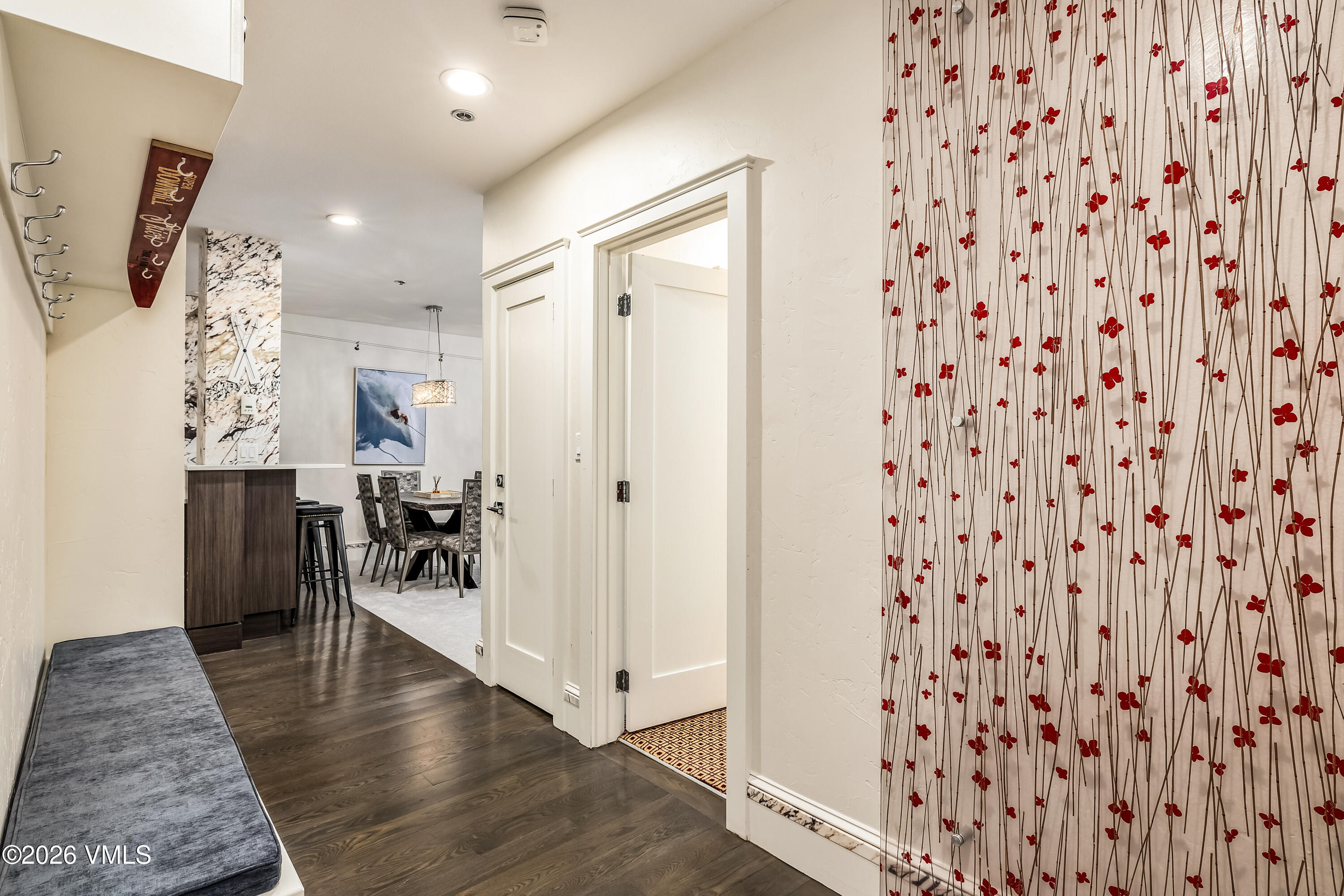 311 Offerson Road, Unit 223 Beaver Creek, CO 81620 - Photo 6 of 37 a hallway with wooden floor and couch