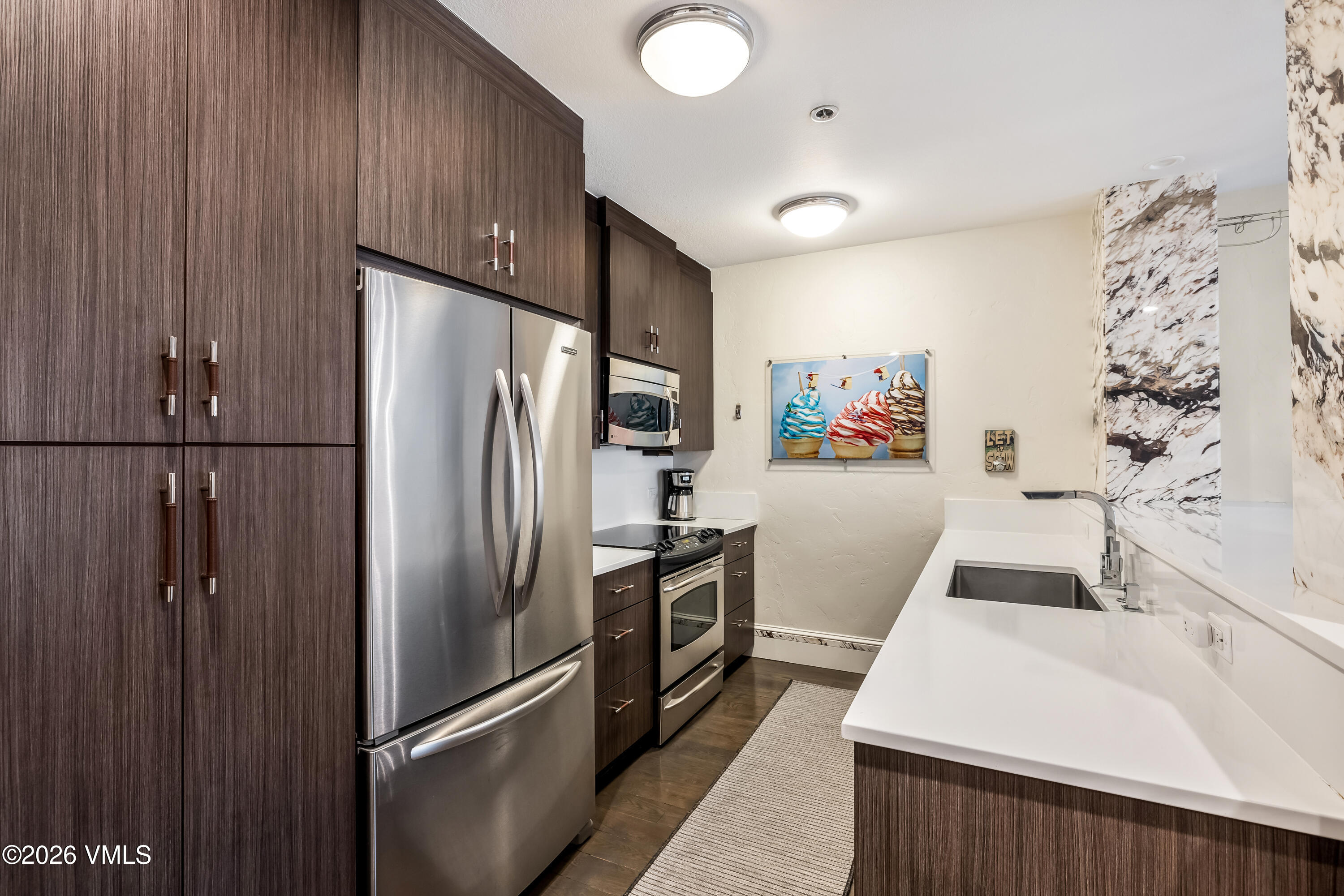 311 Offerson Road, Unit 223 Beaver Creek, CO 81620 - Photo 9 of 37 a kitchen with stainless steel appliances a refrigerator and a sink