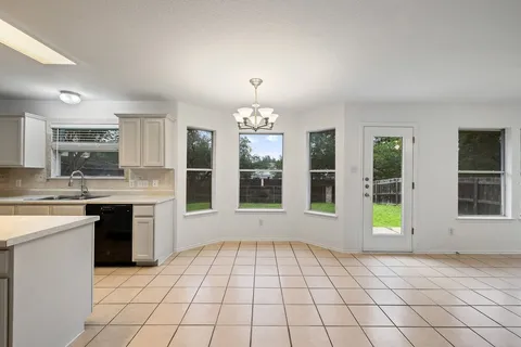 a view of an empty room with a kitchen