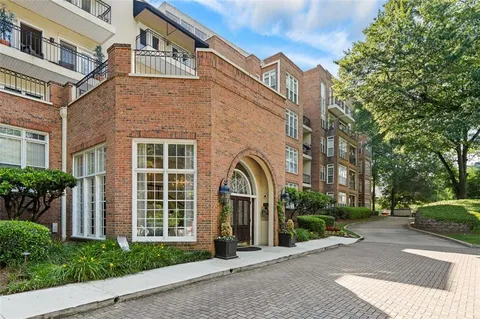 a front view of a building with a garden