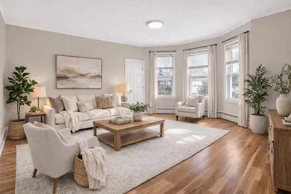 a bedroom with a bed couch and window