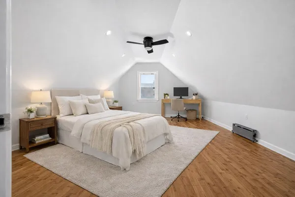 a view of a livingroom with wooden floor and a ceiling fan