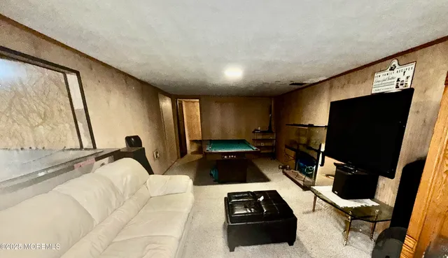 a kitchen with a sink a window and a flat screen tv