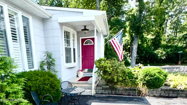 a front view of a house with plants