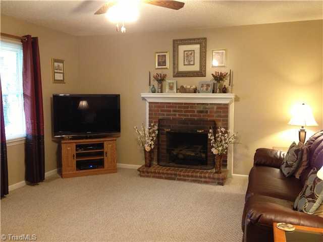 5677 Racine Road Randleman, NC 27317 - Photo 4 of 12 Living Room. Warm, comfortable living room with brick fireplace and gas logs.