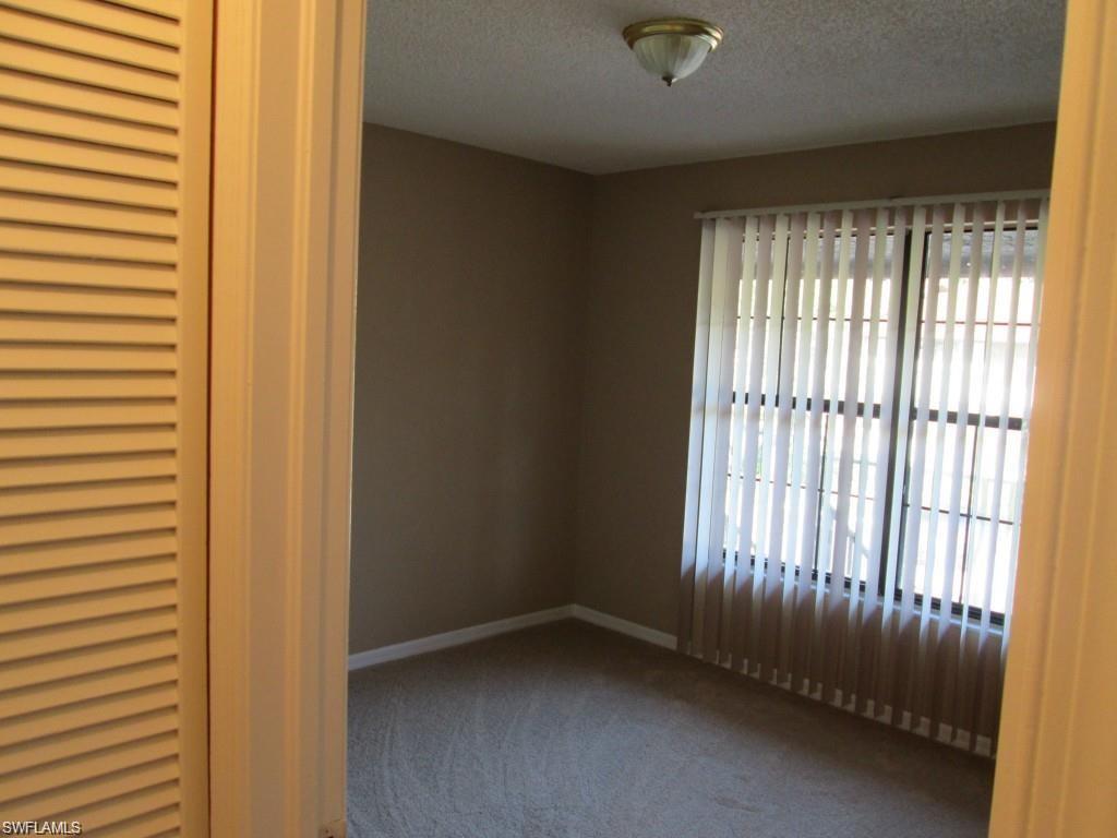 5355 Treetops Drive, Unit S201 Naples, FL 34113 - Photo 4 of 7 a view of an empty room with a window