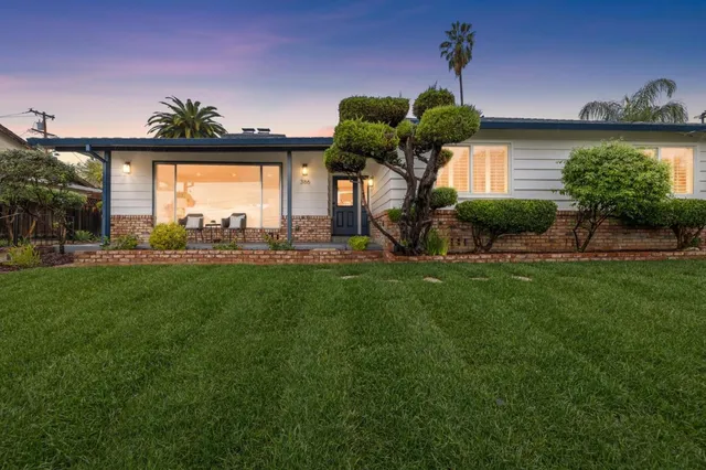 a front view of a house with garden