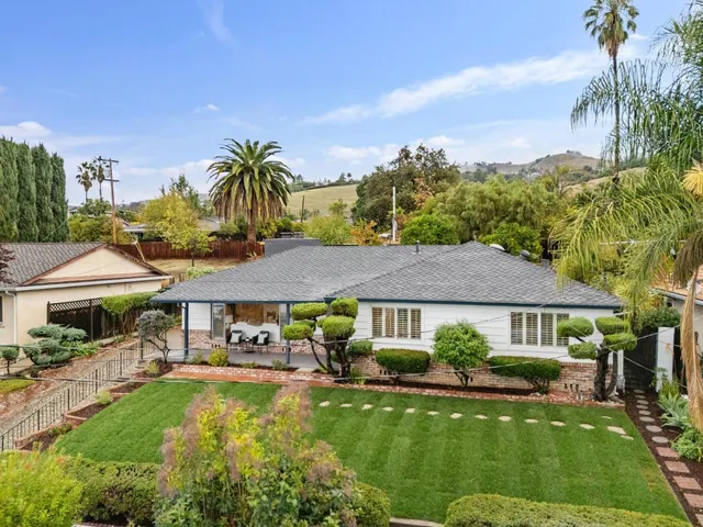 a front view of house with a garden and patio
