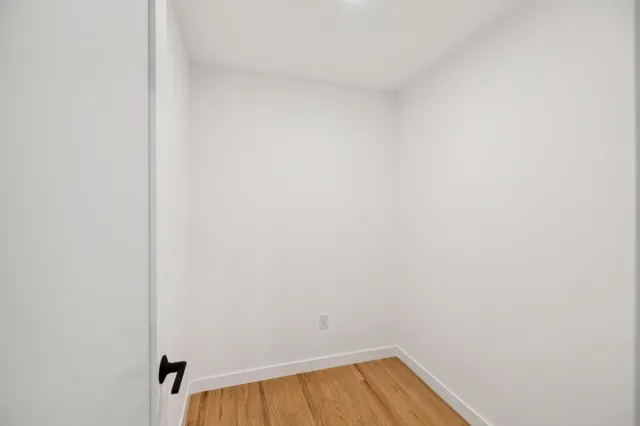a backyard of a house with potted plants and trees