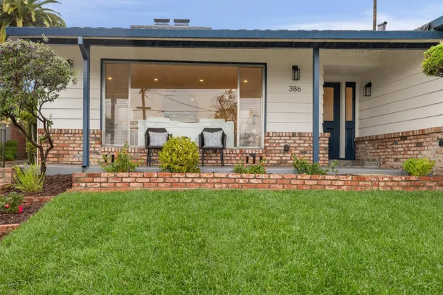 a dining room with furniture and a floor to ceiling window