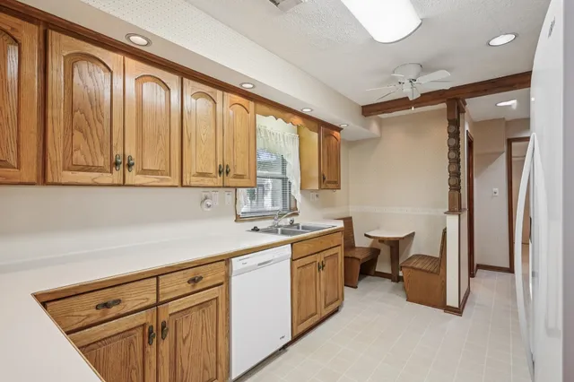 a kitchen with a sink cabinets and window