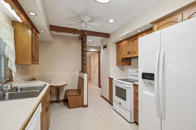 a kitchen with a sink stove and refrigerator