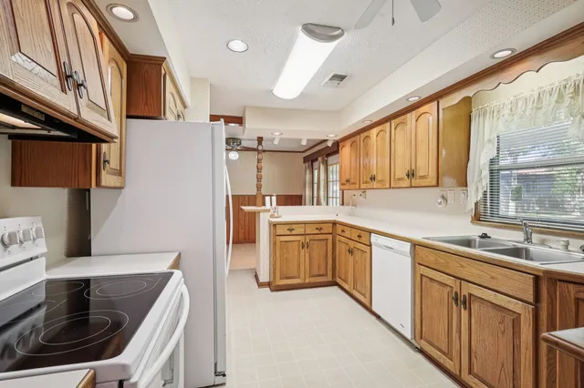 a kitchen that has a sink and a stove in it