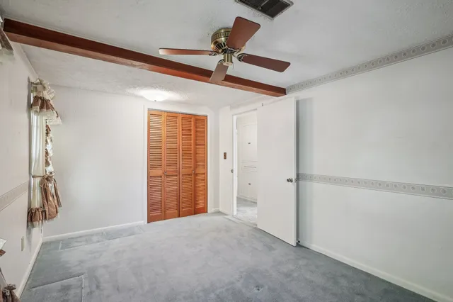 a view of empty room with ceiling fan