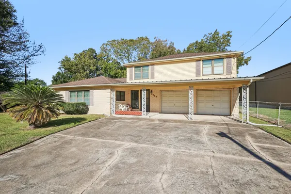 a front view of a house with a garden and entryway