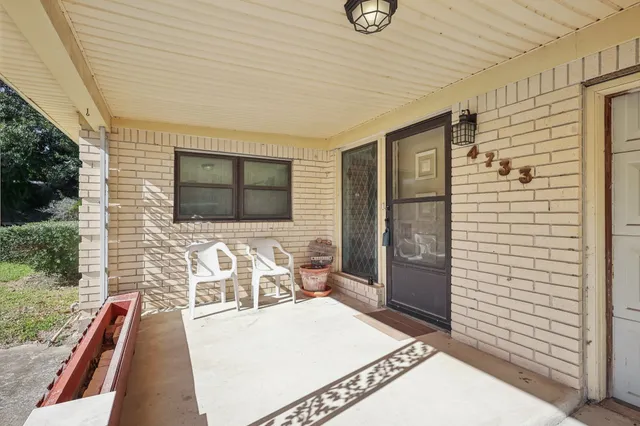 a view of a patio with table and chairs with wooden floor and fence