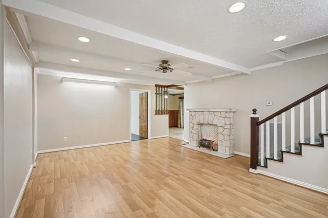 a view of a livingroom with wooden floor and a ceiling fan