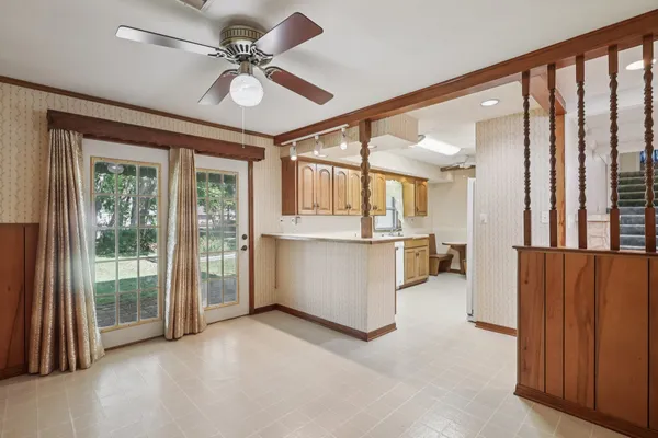 a view of a kitchen with furniture and a ceiling fan