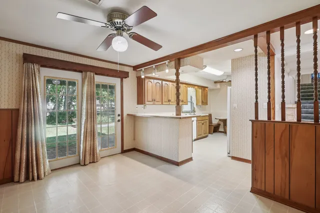 a view of a kitchen with furniture and a ceiling fan