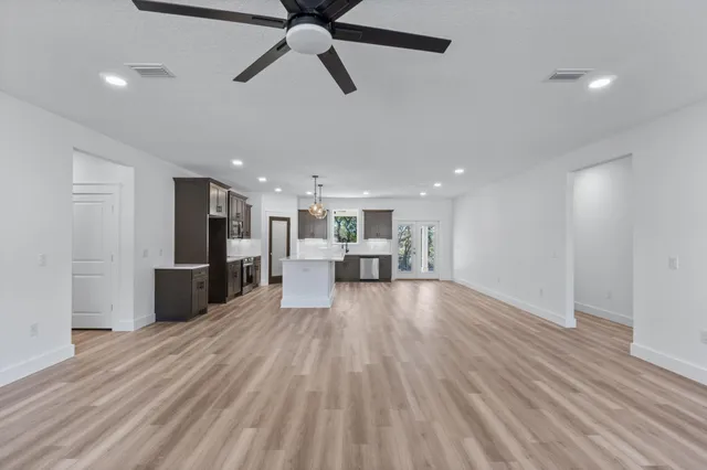 a view of a kitchen with a sink and a refrigerator