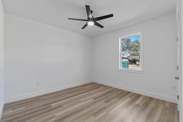 a view of a room with a window and a ceiling fan