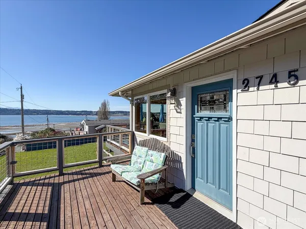 a view of a balcony with couch and wooden floor
