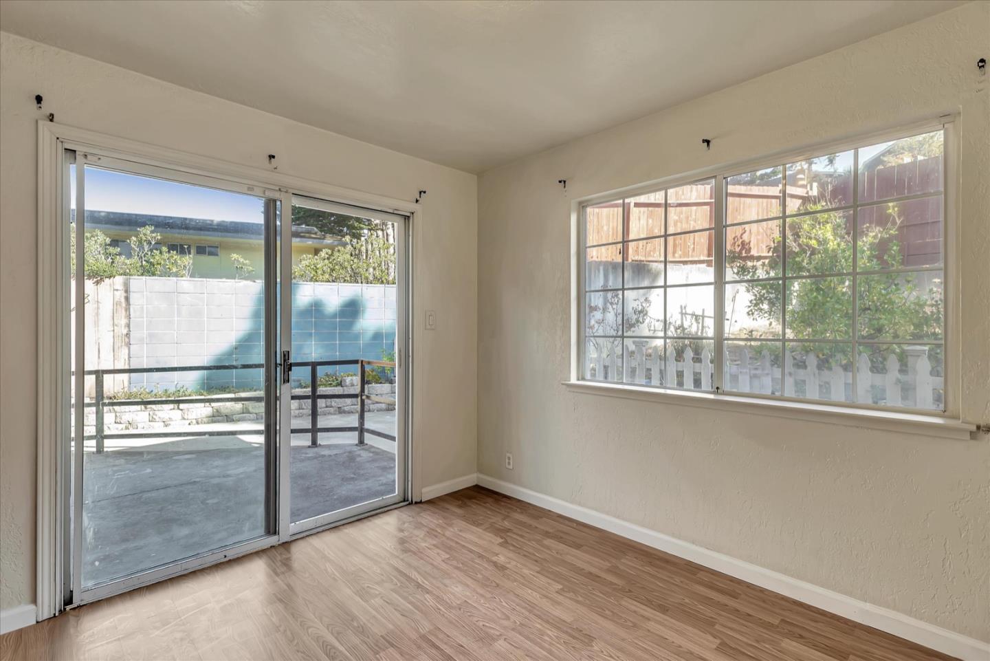 675 Crespi Drive Pacifica, CA 94044 - Photo 11 of 55 a view of an empty room with wooden floor and a window