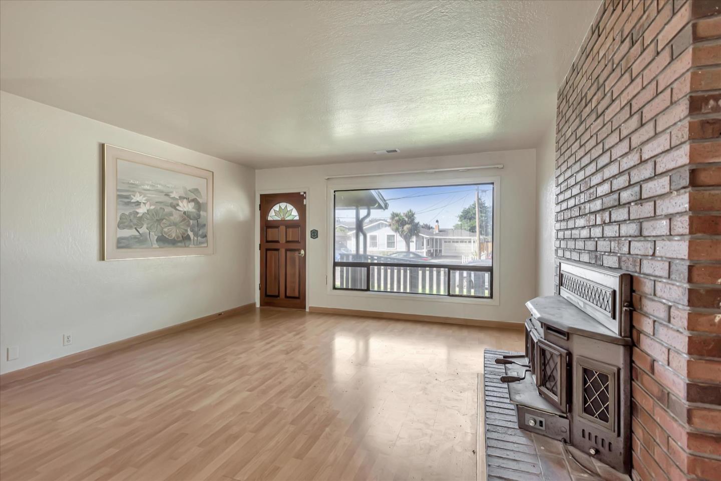675 Crespi Drive Pacifica, CA 94044 - Photo 13 of 55 a view of an empty room with wooden floor and a window