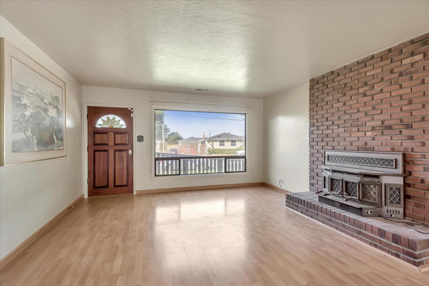 675 Crespi Drive Pacifica, CA 94044 - Photo 14 of 55 a view of an empty room with wooden floor and a window