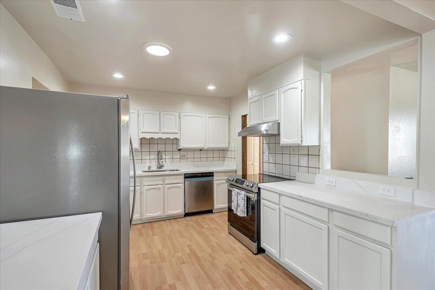 675 Crespi Drive Pacifica, CA 94044 - Photo 15 of 55 a kitchen with stainless steel appliances granite countertop a sink stove and refrigerator