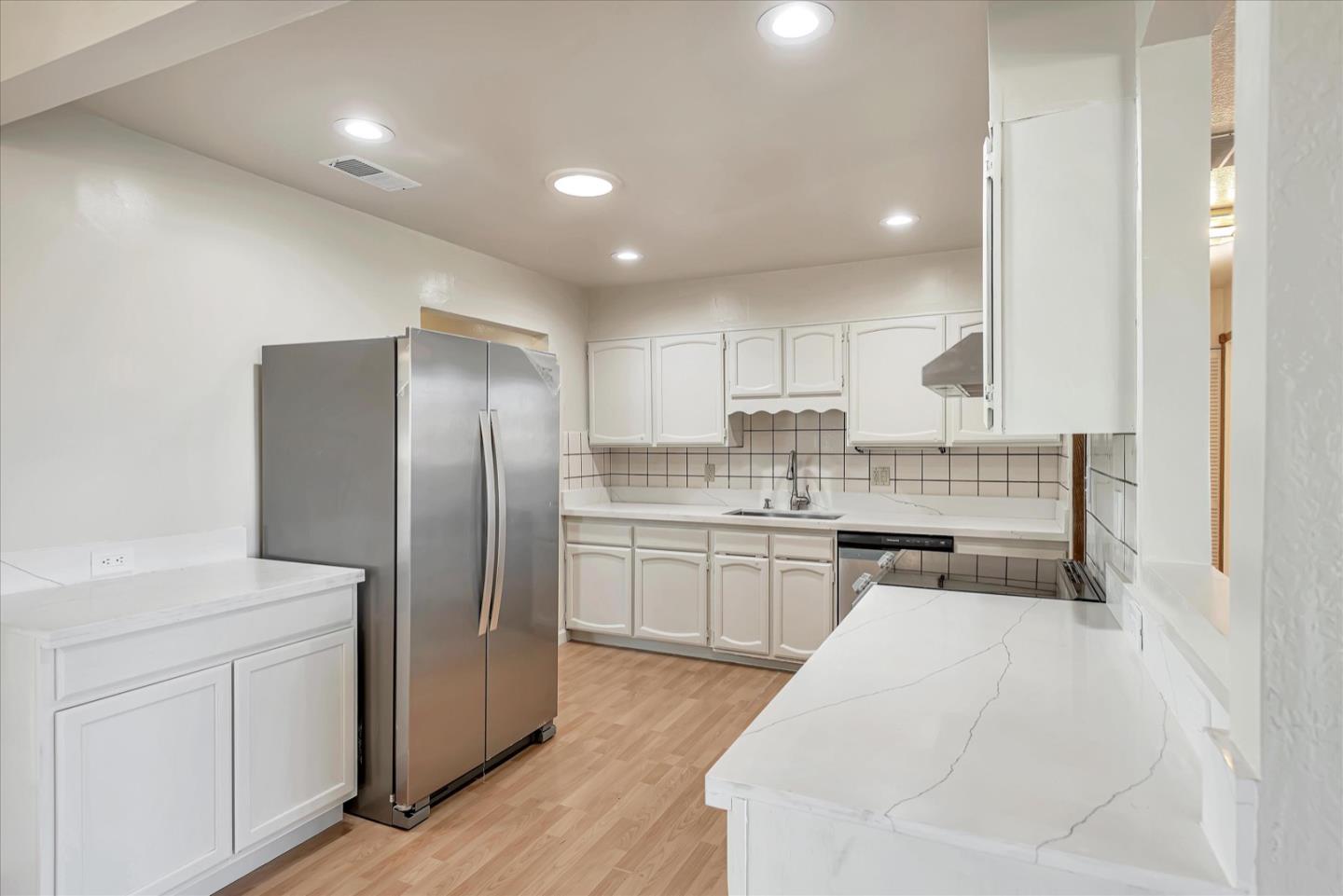675 Crespi Drive Pacifica, CA 94044 - Photo 16 of 55 a kitchen with a refrigerator sink and cabinets