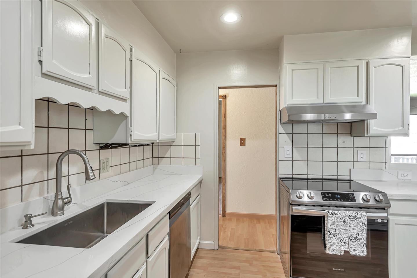 675 Crespi Drive Pacifica, CA 94044 - Photo 17 of 55 a kitchen with kitchen island a sink a stove and refrigerator