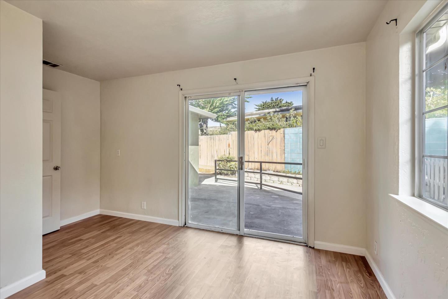 675 Crespi Drive Pacifica, CA 94044 - Photo 29 of 55 a view of an empty room with wooden floor and a window