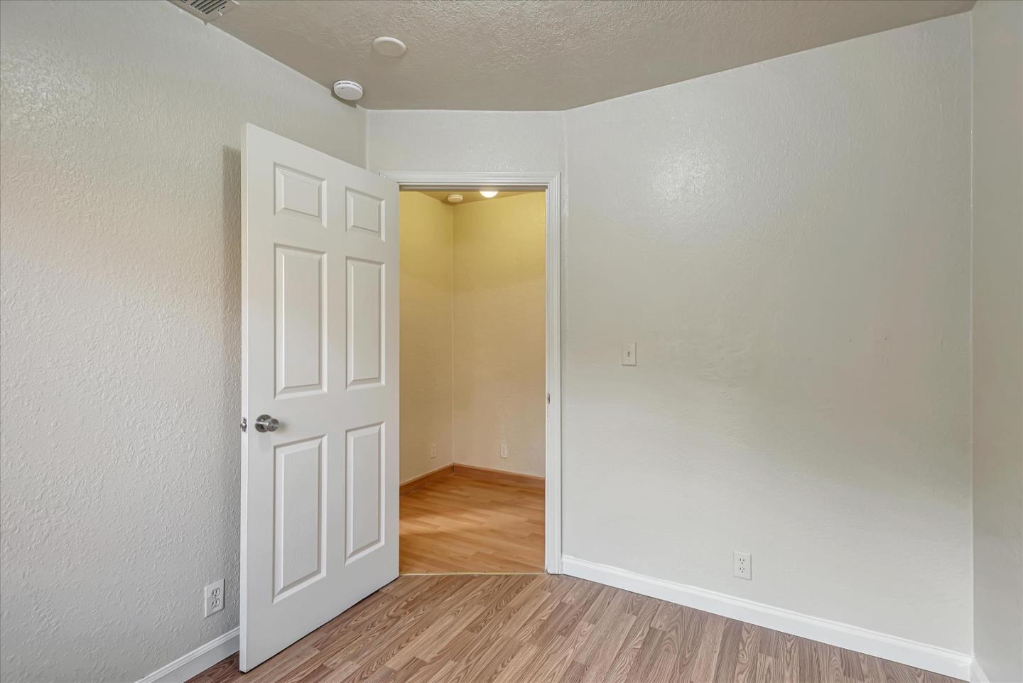 675 Crespi Drive Pacifica, CA 94044 - Photo 38 of 55 a view of a hallway with wooden floor