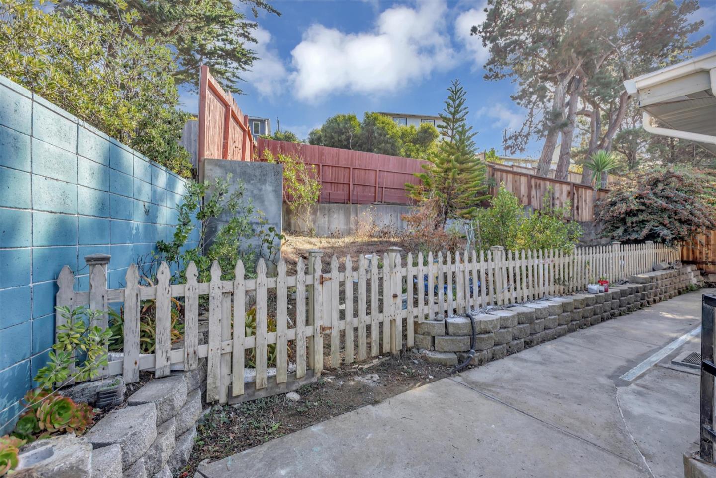675 Crespi Drive Pacifica, CA 94044 - Photo 46 of 55 a view of a house with a small yard and wooden fence