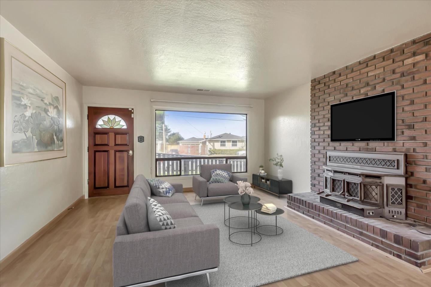 675 Crespi Drive Pacifica, CA 94044 - Photo 5 of 55 a living room with furniture and a flat screen tv