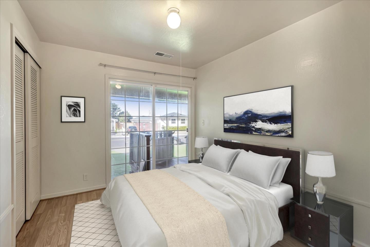 675 Crespi Drive Pacifica, CA 94044 - Photo 10 of 55 a bedroom with a bed and a lamp on dresser