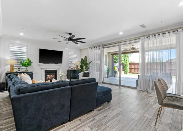 a living room with furniture a large window and a flat screen tv